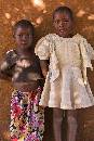 Two Girls at Wall (800Wx1200H) - Two Girls at Wall in Zambian Village - 2010 